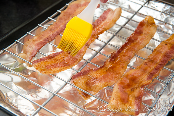 Brush the bacon slices with the sorghum glaze