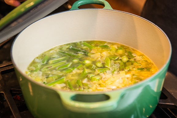 Simmer the asparagus with the aromatics and chicken broth until very tender
