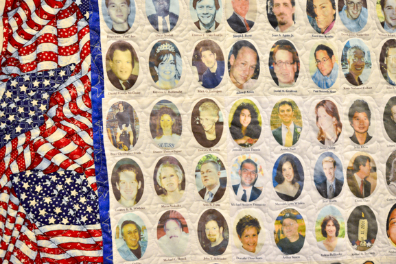 A quilt with photos of everyone who died in the attack