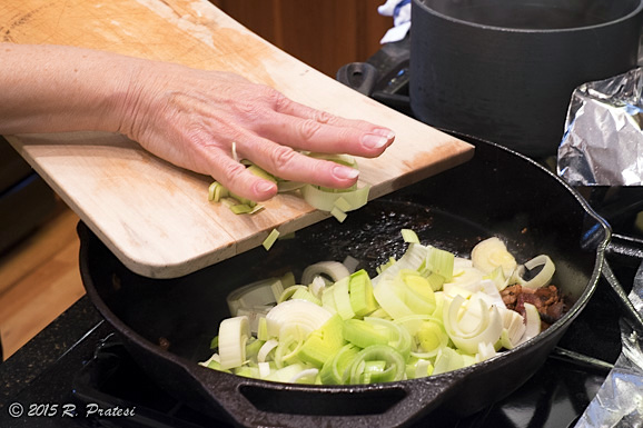 Once the chicken is cooked, remove and add the leeks and garlic to the pan