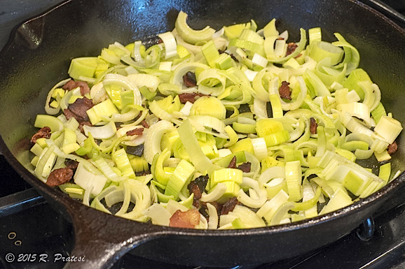 Make a bed of the leeks, bacon, and garlic