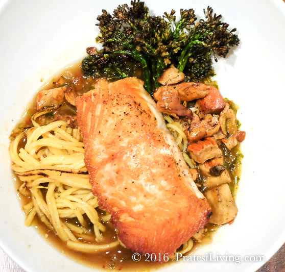 Salmon, pan fried noodles, Broccolini, spicy kale, corn broth, and foraged mushrooms