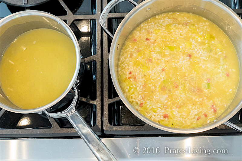 Keep the chicken stock on a low simmer and add it in to the rice mixture gradually