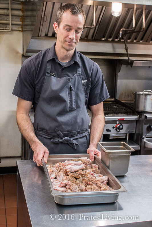 Dean in his kitchen deboning a chicken and preparing chicken roulade